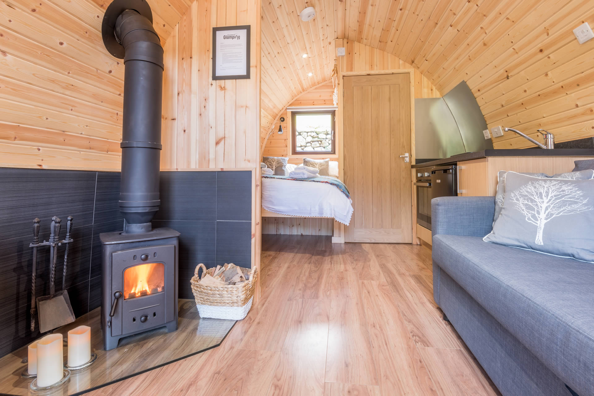 Interior of Grasmere luxury glamping pod with wood burning stove and wifi